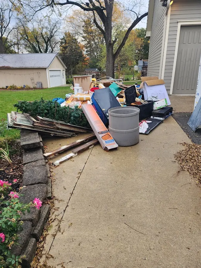 Dumpster being loaded with debris for Roofing Dumpster Rental in Corona de Tucson